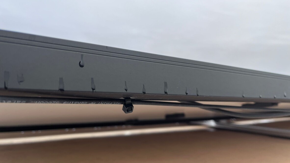 Cable installation beneath solar panel