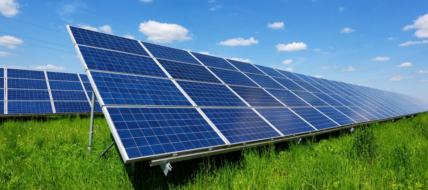 Solar panels under a blue sky, monitored for performance and safety by fiber optic sensing Solar panels under a blue sky, monitored for performance and safety by fiber optic sensing