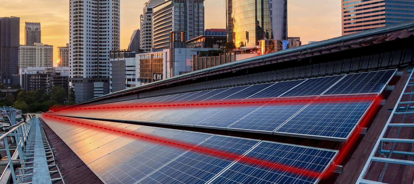 Rooftop solar panels with red lines showing the fiber optic cable for monitoring