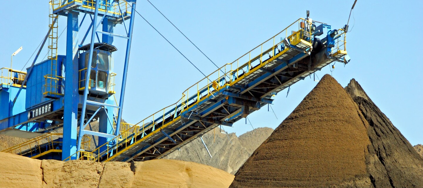 Bulk material conveyor and stockpiles in an industrial setting, monitored for safety by AP Sensing Bulk material conveyor and stockpiles in an industrial setting, monitored for safety by AP Sensing