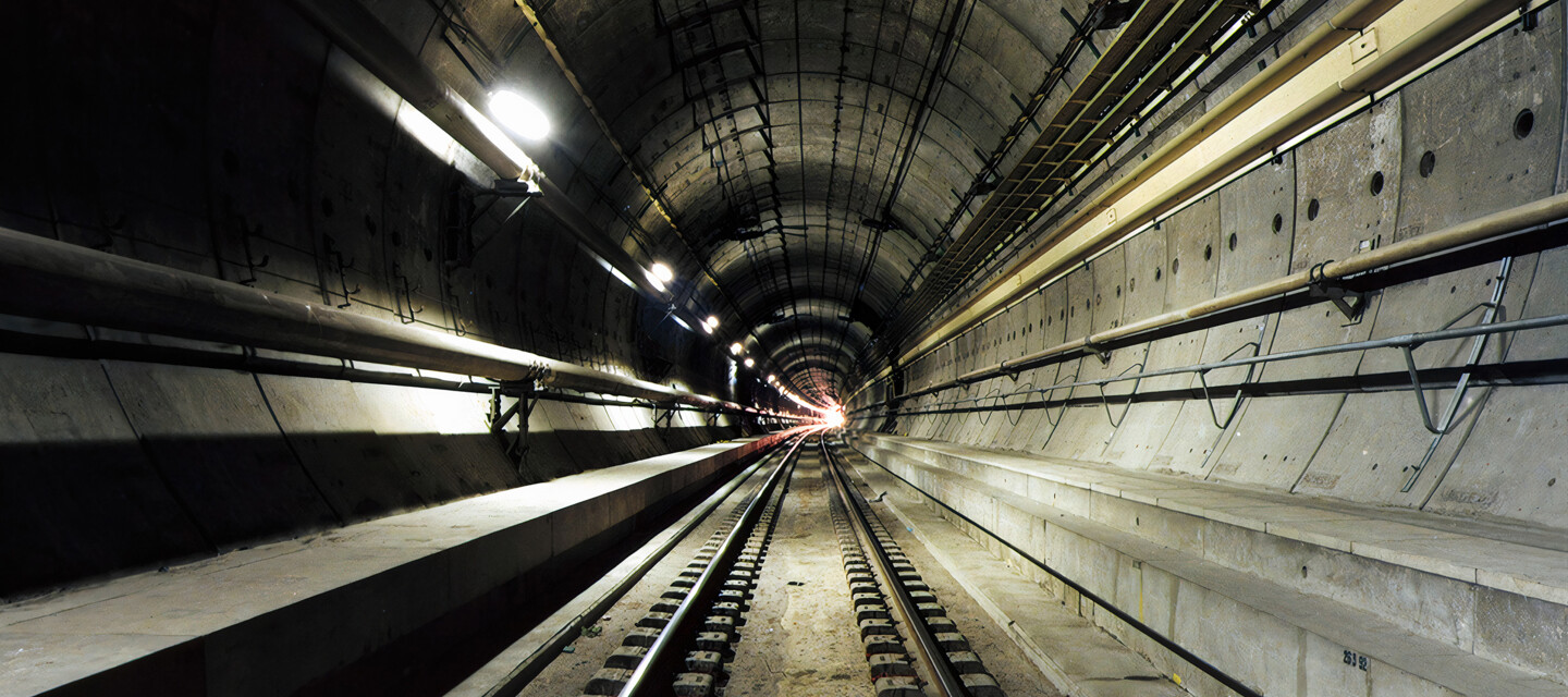 © Eurotunnel Dark subway tunnel with tracks, illustrating infrastructure monitored by AP Sensing fiber optic solutions