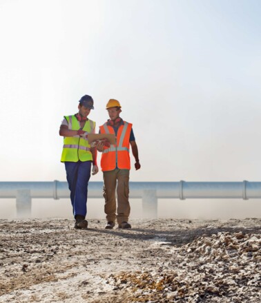 Engineering team in front of a pipeline