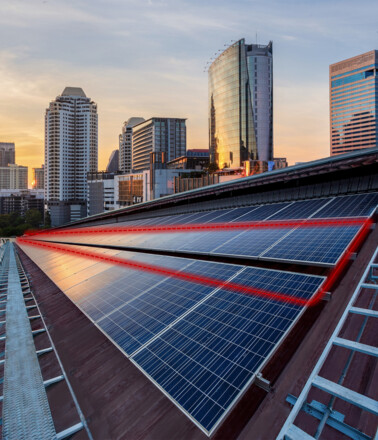 Rooftop solar panels with red lines showing the fiber optic cable for monitoring