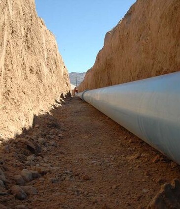 Large pipeline being installed in trench, suitable for AP Sensing fiber optic monitoring Large pipeline being installed in trench, suitable for AP Sensing fiber optic monitoring