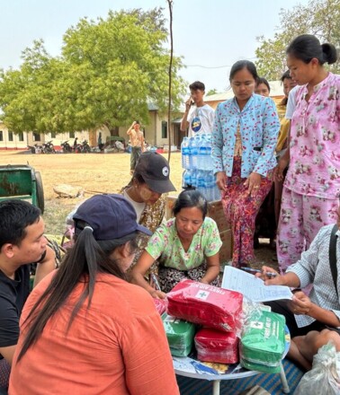Community receiving essential aid, highlighting the need for infrastructure monitoring to prevent disruptions Community receiving essential aid, highlighting the need for infrastructure monitoring to prevent disruptions