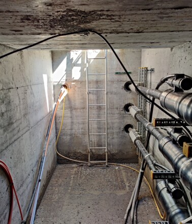 Infrastructure tunnel with power cables, showcasing assets monitored by AP Sensing's distributed fiber optic sensing solutions