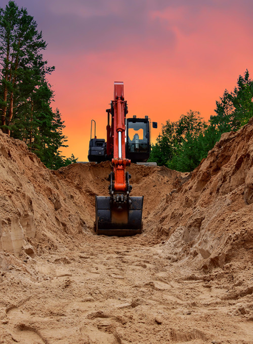 Excavator threatening underground cables and pipelines