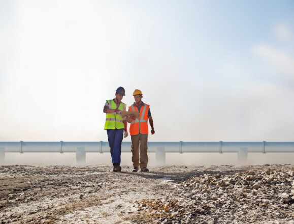 Engineering team in front of a pipeline