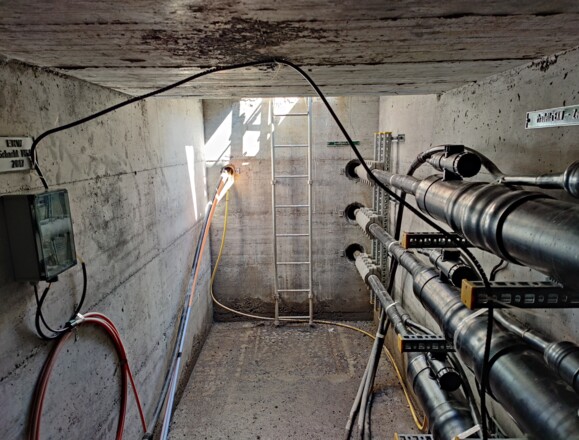 Infrastructure tunnel with power cables, showcasing assets monitored by AP Sensing's distributed fiber optic sensing solutions Infrastructure tunnel with power cables, showcasing assets monitored by AP Sensing's distributed fiber optic sensing solutions