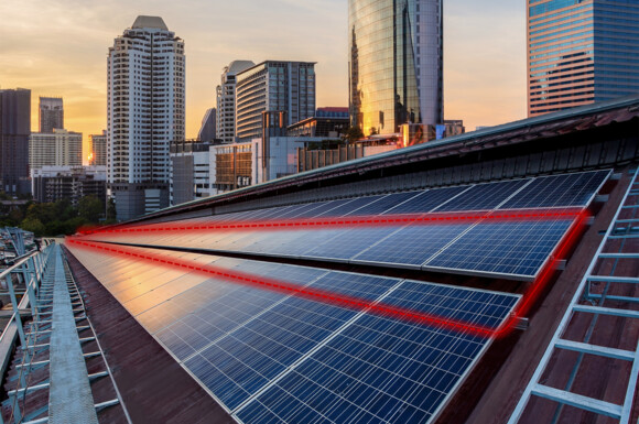 Rooftop solar panels with red lines showing the fiber optic cable for monitoring Rooftop solar panels with red lines showing the fiber optic cable for monitoring