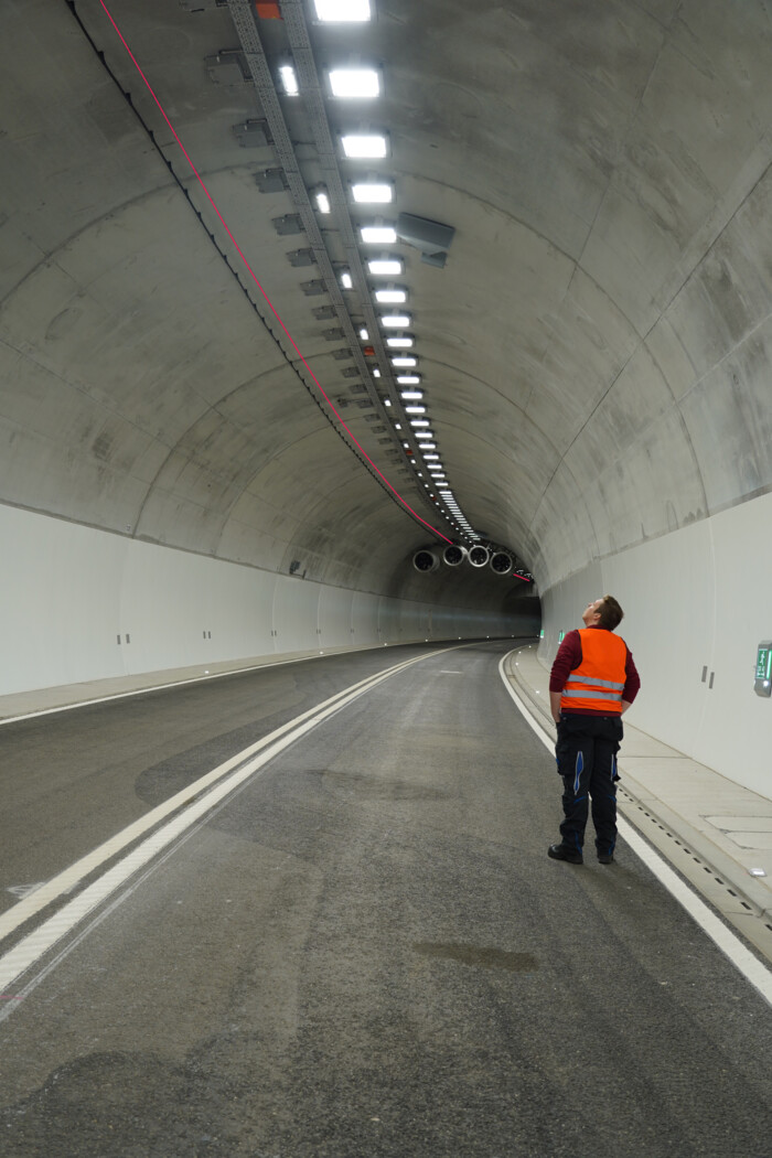 Figure 2: Fiber optic cables, highlighted in red for visibility Man in a tunnel inspecting critical infrastructure components monitored by AP Sensing systems